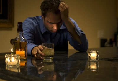 man with hangover hand on forehead
